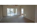 A sunlit living room featuring sliding glass doors and neutral carpeting at 1573 Southwood Dr., Surfside Beach, SC 29575