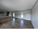Spacious living area features wood-look floors, recessed lighting, and large windows overlooking the outdoors at 2494 Newton Rd., Aynor, SC 29511