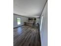 Bright and airy living space with wood-look floors, an island, and ample natural light from the windows at 2494 Newton Rd., Aynor, SC 29511