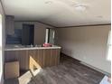 Open-concept kitchen with granite countertops, modern appliances, and dark wood cabinetry at 2500 Newton Rd., Aynor, SC 29511