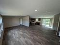 Open living room and kitchen with vinyl floors, recessed lighting, and sliding glass doors to the deck at 2500 Newton Rd., Aynor, SC 29511