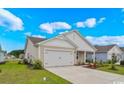 Single story home with a white garage door, neutral siding, and well-maintained front lawn at 3038 Deerberry Place, Longs, SC 29568