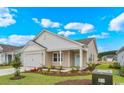 Well-manicured single-Gathering home with a 2-car garage, tidy lawn, and professionally landscaped yard at 3038 Deerberry Place, Longs, SC 29568