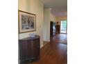 Inviting home entryway featuring hardwood floors, a decorative table, and eye-catching artwork at 5864 Crestwood Dr., Myrtle Beach, SC 29578