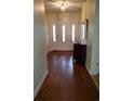 Inviting foyer featuring a gleaming hardwood floor, chandelier, and beautiful entry door at 5864 Crestwood Dr., Myrtle Beach, SC 29578