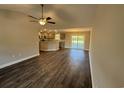 Open-concept living room showcasing modern gray walls, sleek dark wood flooring, and a stylish ceiling fan at Tbd2 Privetts Rd., Conway, SC 29526