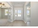 Inviting foyer with a glass-paneled front door, and beautiful flooring at 107 Infinity Ln., Loris, SC 29569