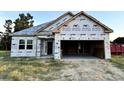 Unfinished single-Gathering house with white wrap exterior and two-car garage with ample space at 108 Infinity Ln., Loris, SC 29569
