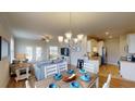 Open living and kitchen area with light and airy feel, featuring a dining table at 35 Delray Dr. # 1-E, Murrells Inlet, SC 29576