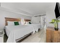 Bright bedroom featuring two queen beds, neutral walls, and modern decor at 7200 Ocean Blvd. N # 254, Myrtle Beach, SC 29572