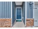 Inviting front entryway with a blue door, stone accents, and a neutral color palette at 4723 Huckleberry Ln., Conway, SC 29526