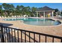 Community pool featuring many lounge chairs, covered area, and a kid friendly shallow section at 516 Papyrus Circle # 516, Little River, SC 29566