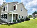 Charming home exterior with manicured lawn, attractive landscaping, and neutral siding at 516 Papyrus Circle # 516, Little River, SC 29566