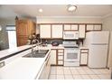 Efficient kitchen with white appliances, tile flooring, and light countertops at 9550 Dunes Gable Dr. # F, Myrtle Beach, SC 29572
