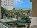View of the pool area surrounded by tropical vegetation at 9994 Beach Club Dr. # 205, Myrtle Beach, SC 29572