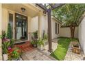 Inviting entryway with pergola, landscaping, and tiled pathway at 11 Valencia Circle, Myrtle Beach, SC 29572