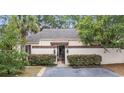 Front view of charming house with gated entry and landscaping at 11 Valencia Circle, Myrtle Beach, SC 29572