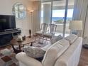 Ocean view living room with comfy seating and wood floors at 9840 Queensway Blvd. # 330, Myrtle Beach, SC 29572