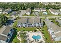 Aerial view showcases a blue condo complex, pool, and well-maintained landscaping, parking and other homes at 1930 Bent Grass Dr. # 40K, Surfside Beach, SC 29575