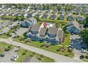 Aerial view of blue condo buildings, a sparkling blue pool, and a well manicured lawn and parking areas at 1930 Bent Grass Dr. # 40K, Surfside Beach, SC 29575