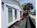 Inviting deck with red chairs, perfect for outdoor lounging and enjoying the coastal breezes at 6001 - 5410 S Kings Hwy., Myrtle Beach, SC 29575