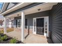 Gray house with a black front door and white columns at 1124 Cypress Shoal Dr., Conway, SC 29526