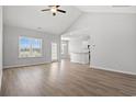 Bright living room with large windows and open floor plan, features wood-look flooring at 1124 Cypress Shoal Dr., Conway, SC 29526