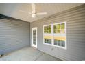 Covered patio with gray siding, white trim, and a ceiling fan at 1124 Cypress Shoal Dr., Conway, SC 29526