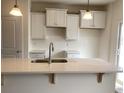 Modern kitchen featuring white cabinets, a quartz countertop, and a stainless steel faucet at 1060 Log Cabin Rd., Loris, SC 29569