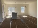 Bright, partially finished kitchen area with a center island, modern light fixtures and sliding glass doors at 1060 Log Cabin Rd., Loris, SC 29569