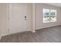 Bright entryway with gray vinyl plank flooring and a white door at 315 Acosta Circle, Conway, SC 29527