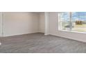 Spacious living room with gray vinyl plank flooring and large window at 315 Acosta Circle, Conway, SC 29527