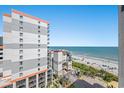 Balcony view featuring a beach, blue ocean, and neighboring high-rise condos at 7100 N Ocean Blvd. # 1023, Myrtle Beach, SC 29572