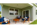 Covered patio with seating area, perfect for outdoor relaxation at 304 Glade Ct., Loris, SC 29569