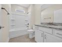 Clean bathroom with tub, white vanity with granite countertops, chrome fixtures, and tile flooring at 582 Beckham Ct., Murrells Inlet, SC 29576