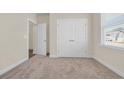 Bedroom featuring neutral walls, plush carpet, window with blinds, closet, and a doorway leading into the room at 582 Beckham Ct., Murrells Inlet, SC 29576