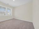 Bright bedroom features plush carpet, neutral walls, and a window with blinds allowing ample natural light at 582 Beckham Ct., Murrells Inlet, SC 29576