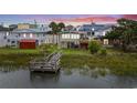 Elevated view of cottage, private dock, and peaceful marsh at 209 N Dogwood Dr., Garden City Beach, SC 29576