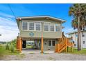 Coastal cottage with elevated design and spacious deck at 209 N Dogwood Dr., Garden City Beach, SC 29576