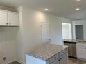 Open-concept kitchen with stainless steel appliances, granite countertops, and a kitchen island at 2275 King Farm Rd., Aynor, SC 29511