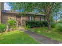 Charming brick condo featuring a cozy front porch with a wooden door and neatly trimmed bushes at 305 Resort Dr. # C12, Myrtle Beach, SC 29588