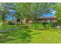 Well-maintained lawn with mature trees and lush greenery in front of the cozy condo building at 305 Resort Dr. # C12, Myrtle Beach, SC 29588