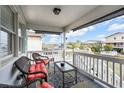 Cozy covered porch featuring comfortable seating and scenic neighborhood views at 404 32Nd Ave. N, North Myrtle Beach, SC 29582