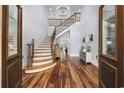 Grand foyer with wood floors, high ceilings, elegant staircase, and decorative lighting fixture at 9318 Cove Dr., Myrtle Beach, SC 29572