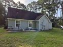 Back exterior features a patio and views of the backyard, with trees providing shade at 938 Fox Hollow Rd., Conway, SC 29526