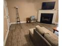 View of the living room with a fireplace, tv, flooring, and a comfortable seating area at 938 Fox Hollow Rd., Conway, SC 29526