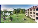 Exterior view of condo buildings backyard with lake access and lush landscaping at 501 Maison Dr. # B10, Myrtle Beach, SC 29572