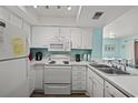 Compact kitchen with essential appliances, white cabinetry, and a practical layout at 501 Maison Dr. # B10, Myrtle Beach, SC 29572