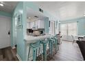 Inviting kitchen area featuring counter seating and views into the adjacent living space at 501 Maison Dr. # B10, Myrtle Beach, SC 29572