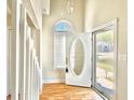 Welcoming entryway with beautiful front door, wood floors, natural light, and staircase leading to the upper level at 829 9Th Ave. S, North Myrtle Beach, SC 29582